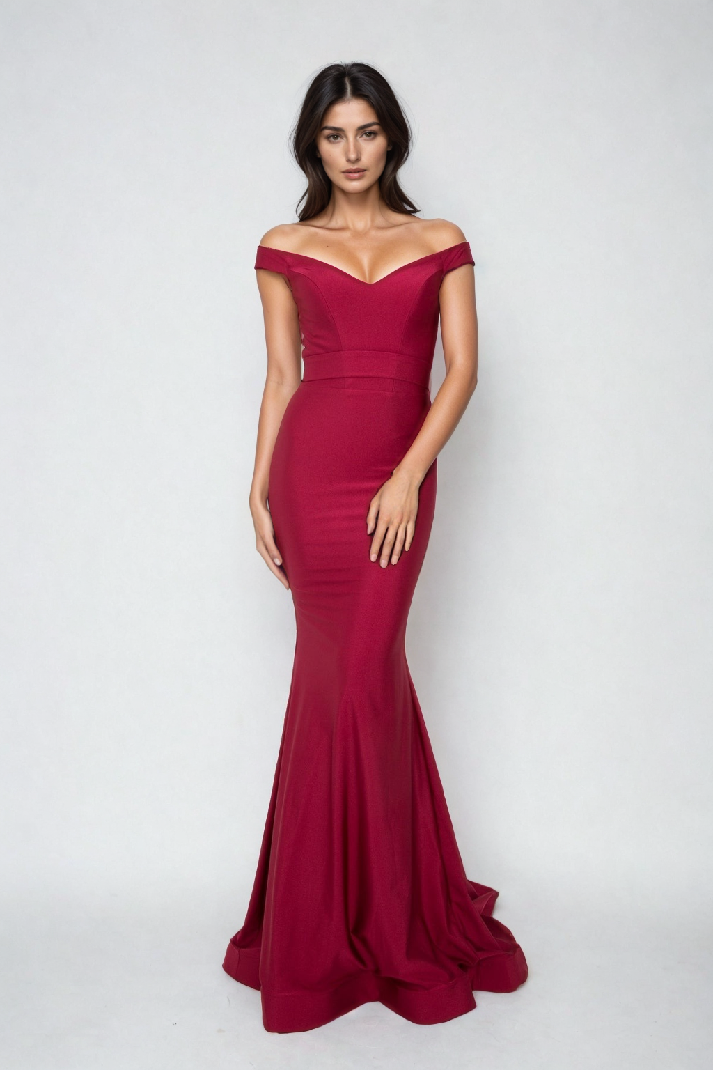 A woman models the Atria Off-the-Shoulder Long Formal Dress 6016H, a fitted, floor-length red gown, standing against a plain light background.